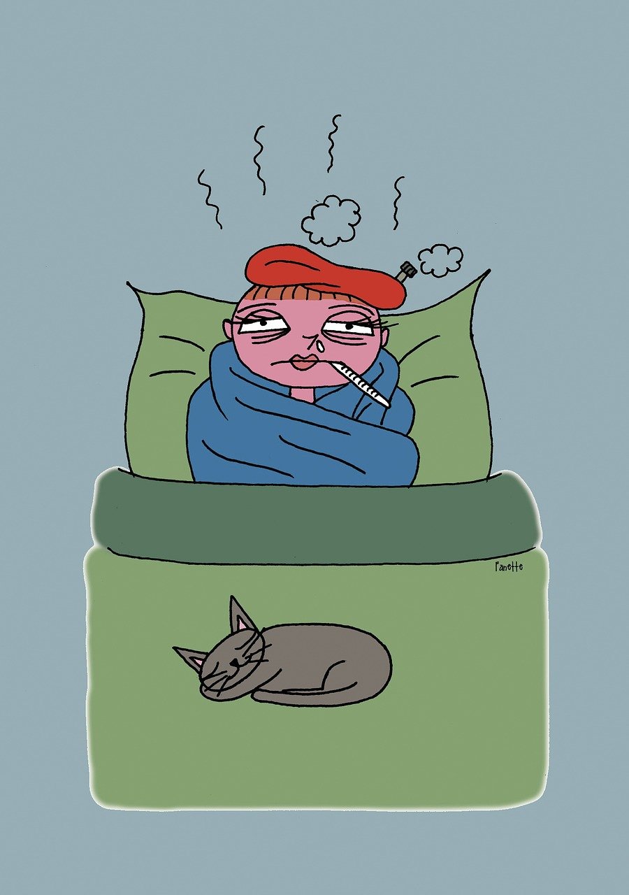 Cartoon image of an ill young woman (teacher for this post) lying in bed, propped up against her pillow, with a red ice pack on top of her head, wrapped in a blue blanket around her shoulders. A cat is curled up at the foot of her bed. She looks like she has a fever and is measuring it with a thermometer in her mouth.